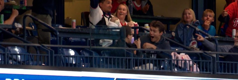 Oh, baby! Fan catches ball while holding infant … without even standing up