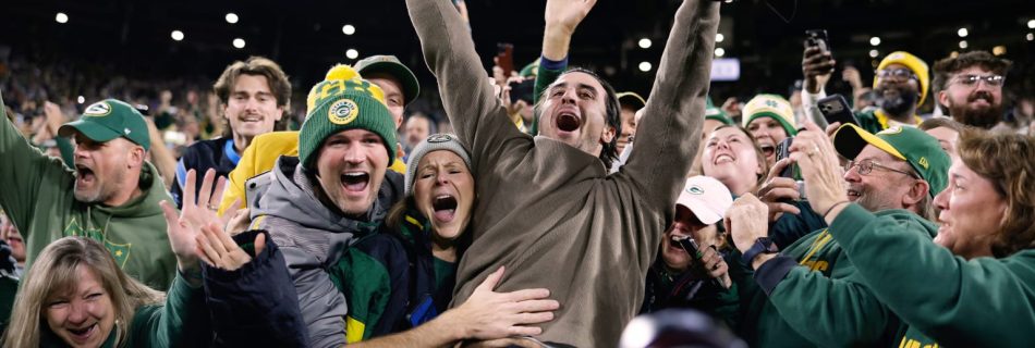 Crew celebrates title at Packers game — complete with a Lambeau Leap