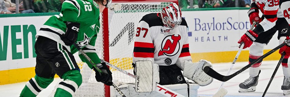 Hellebuyck earns first win with Devils