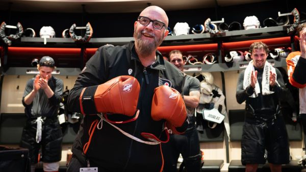 Flyers head coach Tocchet gives game puck to radio broadcaster Myrtetus Flyers head coach Tocchet gives game puck to radio broadcaster Myrtetus